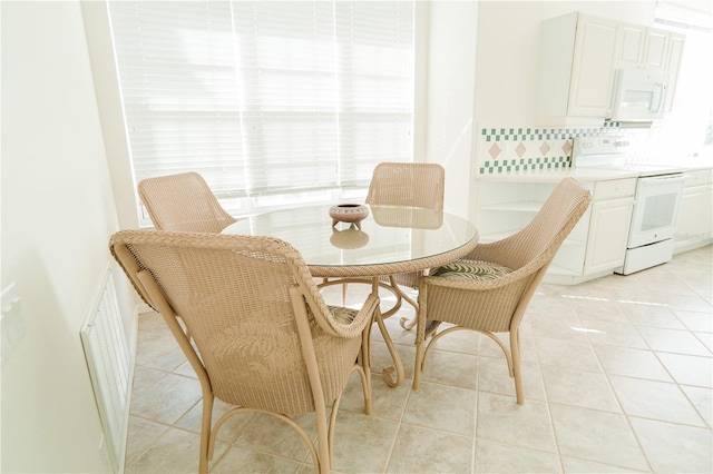 dining area with light tile patterned flooring