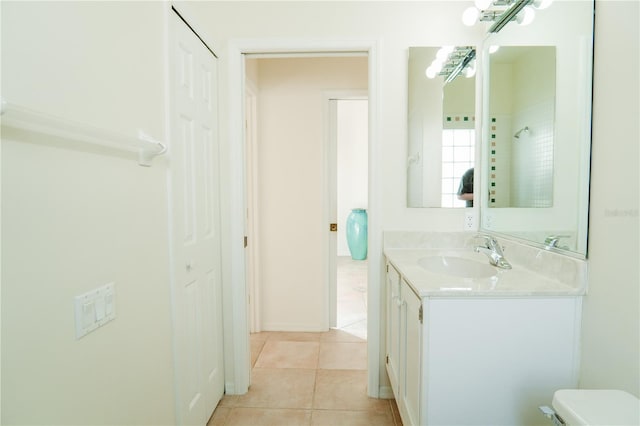 bathroom featuring vanity, toilet, and tile patterned flooring