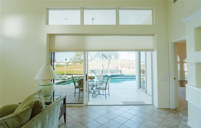 entryway with a wealth of natural light and light tile patterned floors