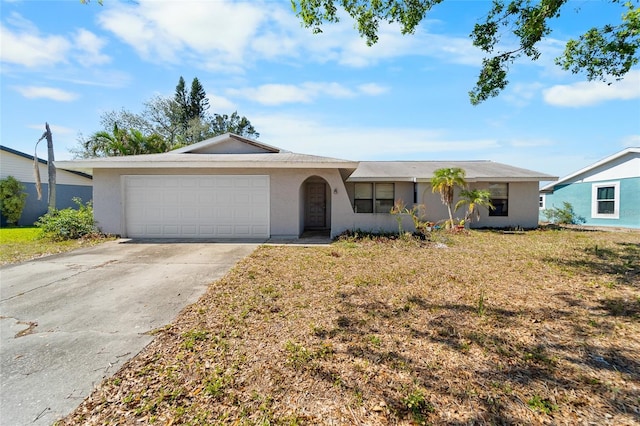 ranch-style house with a garage and a front lawn