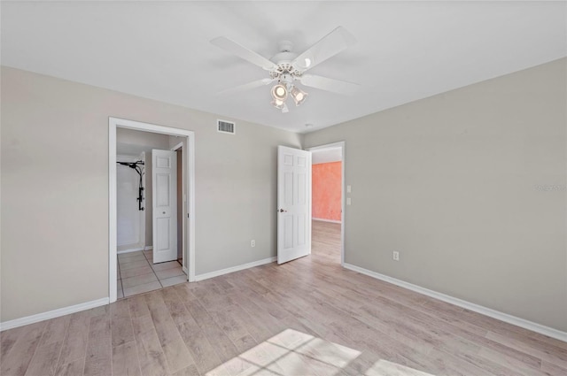 unfurnished bedroom with ceiling fan and light hardwood / wood-style floors