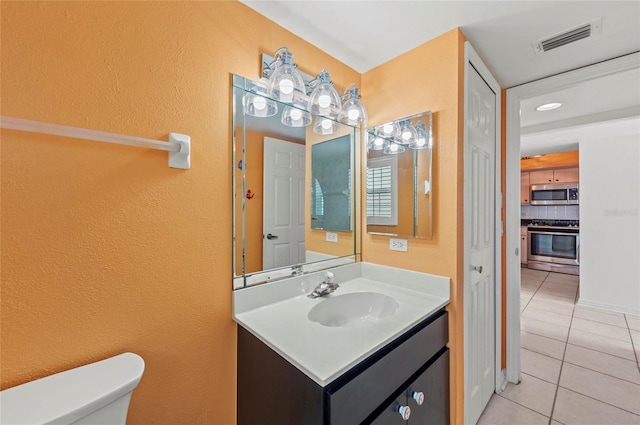 bathroom with tasteful backsplash, vanity, toilet, and tile patterned flooring