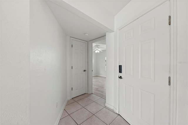 hall featuring light tile patterned floors