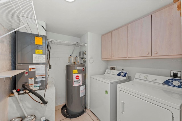 washroom with cabinets, independent washer and dryer, water heater, and light tile patterned floors