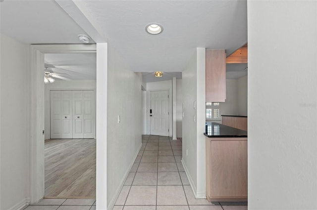 hall with light tile patterned floors