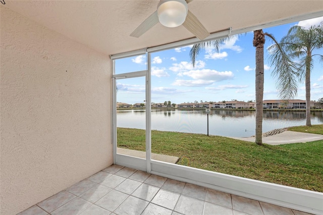 unfurnished sunroom featuring a water view