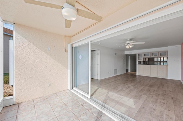 exterior space featuring ceiling fan