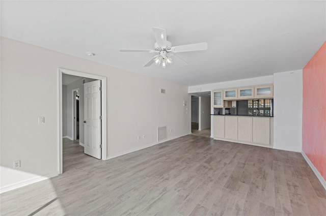 unfurnished living room with light hardwood / wood-style floors and ceiling fan