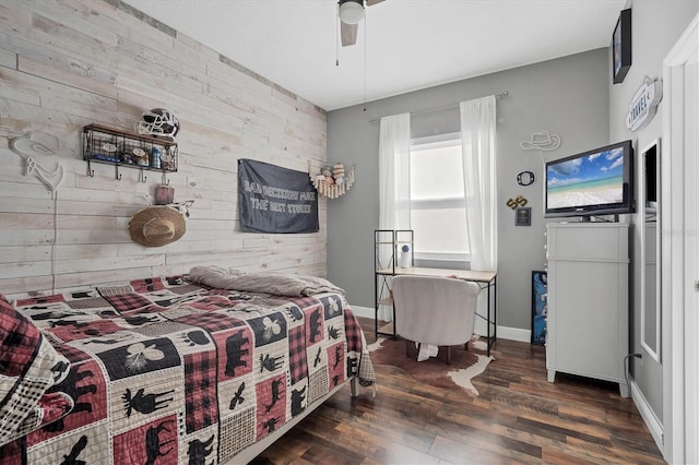 bedroom with dark hardwood / wood-style flooring, ceiling fan, and wood walls