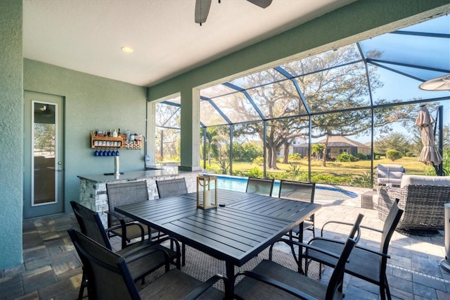 view of patio / terrace with ceiling fan and glass enclosure