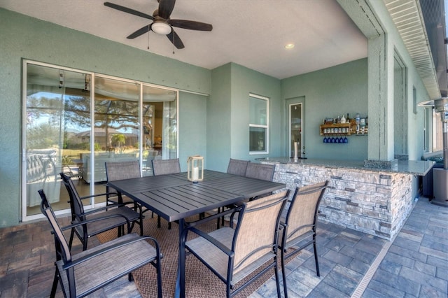 view of patio / terrace with a bar and ceiling fan