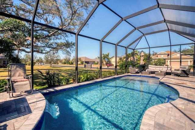 view of pool with outdoor lounge area, a patio, pool water feature, and glass enclosure