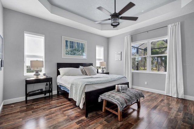 2006 Red Lake Run, Bradenton, FL 34211 - bedroom featuring a tray ceiling, dark wood-style flooring, baseboards, and ceiling fan