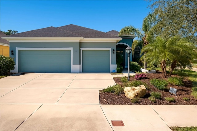 2006 Red Lake Run, Bradenton, FL 34211 - view of front of property featuring concrete driveway, a garage, stucco siding, and roof with shingles