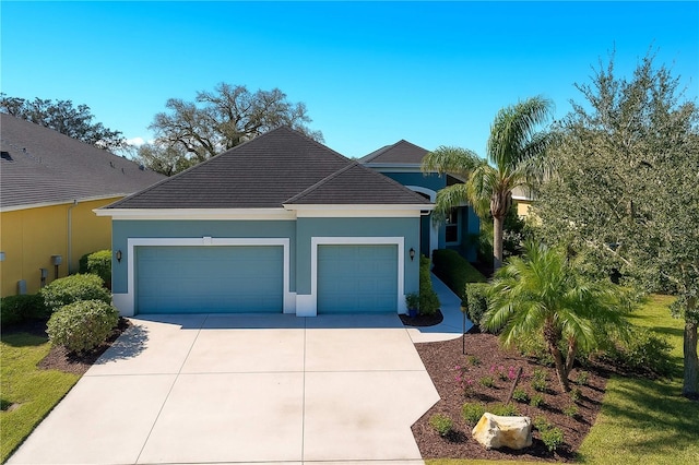 2006 Red Lake Run, Bradenton, FL 34211 - view of front of property featuring an attached garage, concrete driveway, and stucco siding
