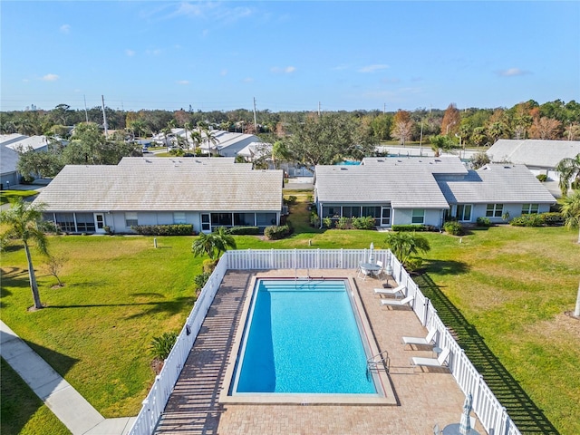 view of swimming pool featuring a yard