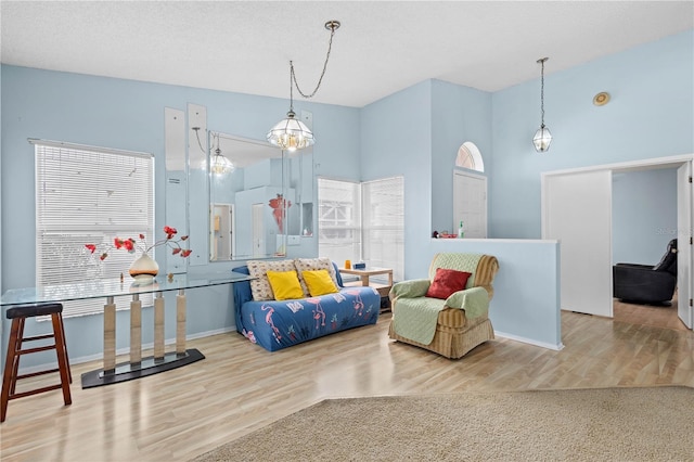 living area featuring a wealth of natural light, a textured ceiling, and light wood-type flooring