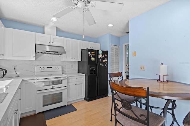 kitchen with white cabinetry, double oven range, black refrigerator with ice dispenser, and light hardwood / wood-style flooring