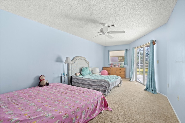 bedroom with ceiling fan, access to exterior, carpet floors, and a textured ceiling