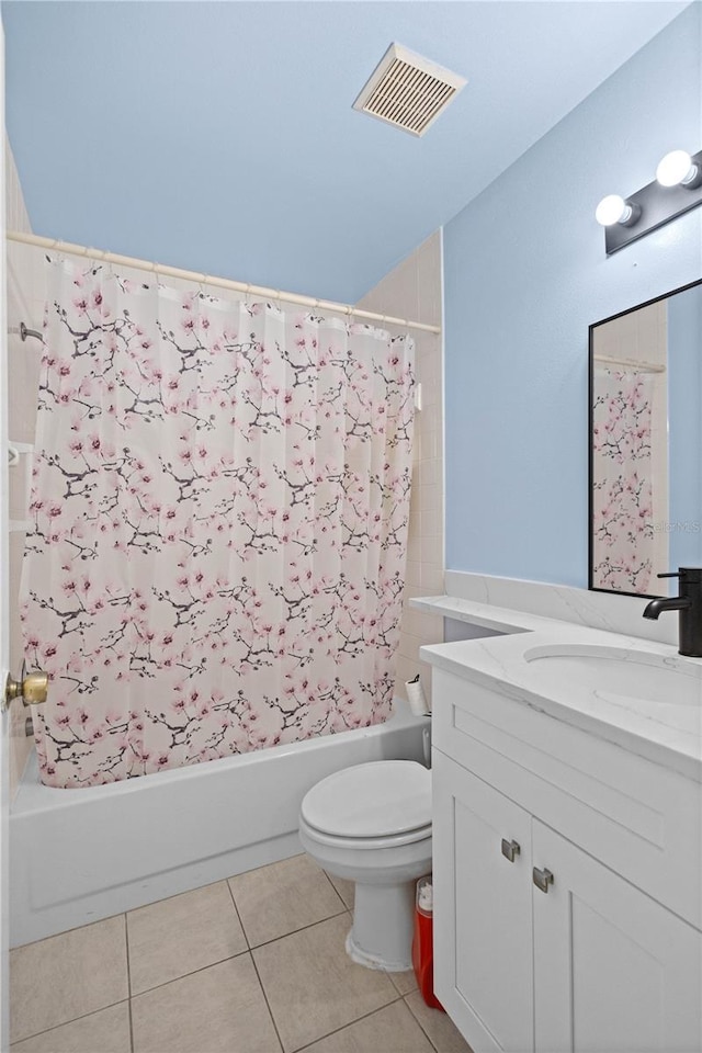 bathroom with toilet, tile patterned floors, vanity, visible vents, and shower / tub combo with curtain