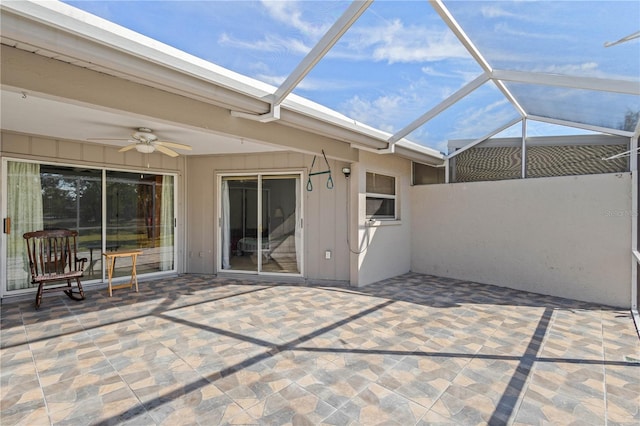 view of patio / terrace featuring glass enclosure and ceiling fan