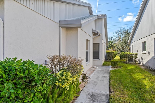 view of home's exterior featuring a yard and stucco siding