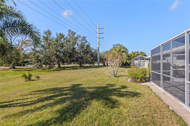 view of yard with glass enclosure