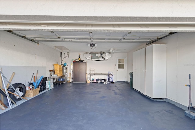 garage featuring electric water heater and a garage door opener