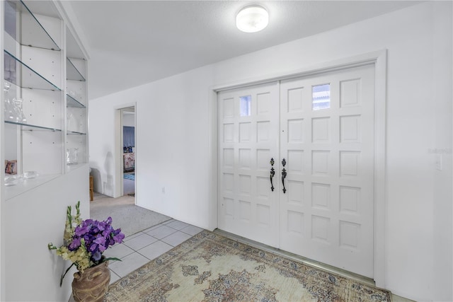 foyer featuring light tile patterned floors