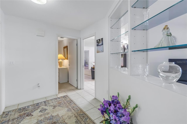 hall with light tile patterned floors