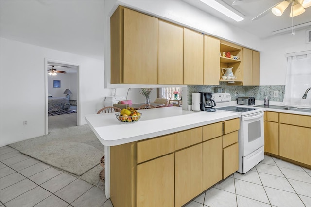 kitchen featuring sink, light brown cabinetry, decorative backsplash, white electric stove, and kitchen peninsula