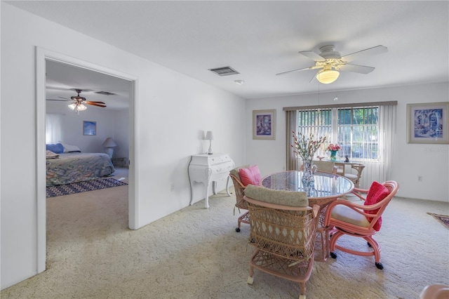 dining room featuring light carpet and ceiling fan