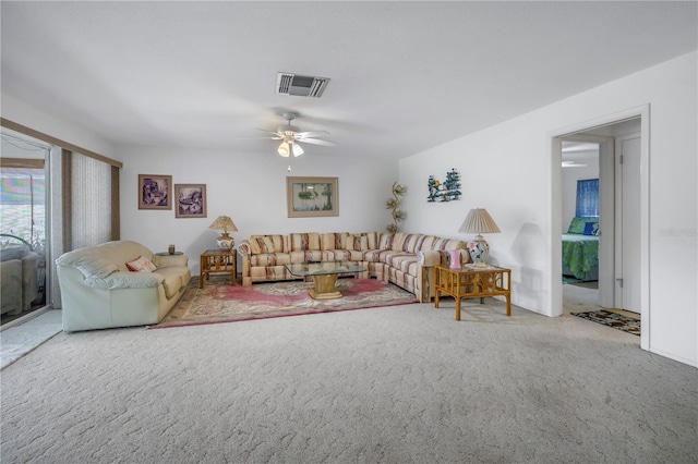 living room with ceiling fan and carpet flooring