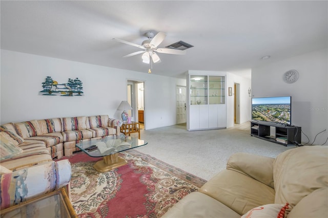 carpeted living room with ceiling fan