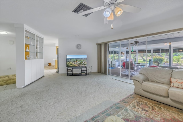 living room featuring ceiling fan and a wealth of natural light