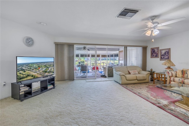 carpeted living room with ceiling fan