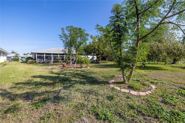 view of yard featuring a sunroom