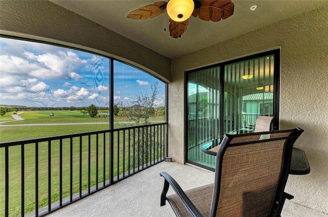 sunroom with a healthy amount of sunlight and ceiling fan