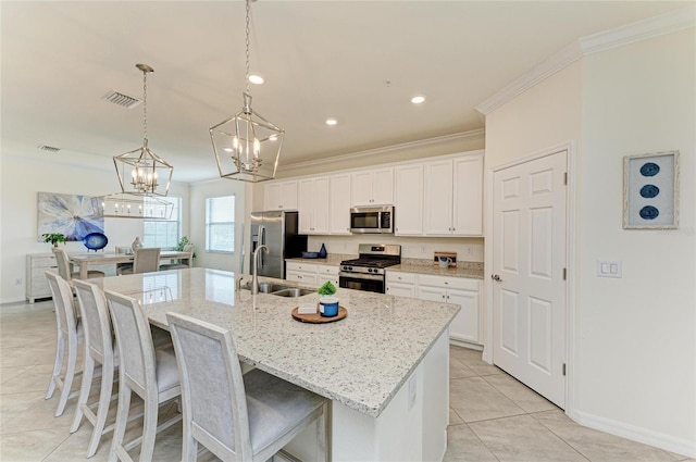 kitchen featuring sink, crown molding, a kitchen island with sink, white cabinetry, and stainless steel appliances