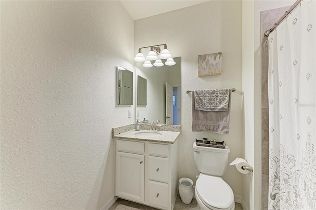 bathroom featuring vanity, curtained shower, and toilet