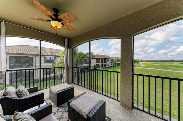 sunroom / solarium featuring ceiling fan