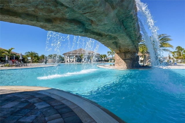 view of pool featuring pool water feature and a gazebo