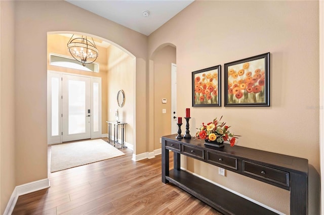 entryway featuring a notable chandelier and hardwood / wood-style flooring