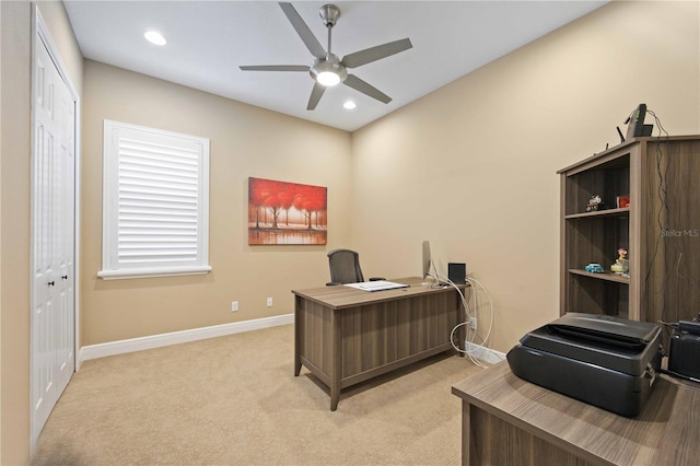 home office with ceiling fan and light carpet