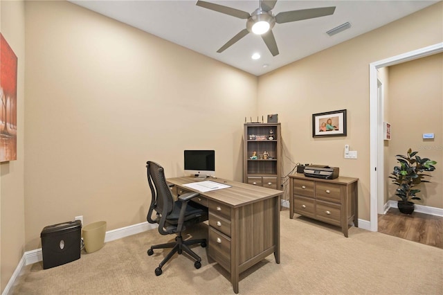 office area featuring light carpet and ceiling fan