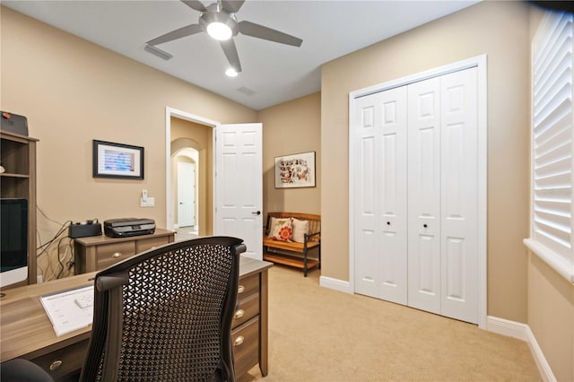 carpeted office featuring ceiling fan