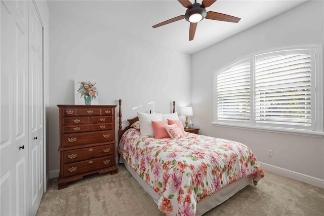 carpeted bedroom featuring a closet and ceiling fan