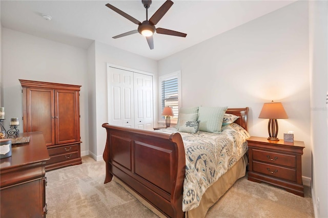 carpeted bedroom featuring a closet and ceiling fan