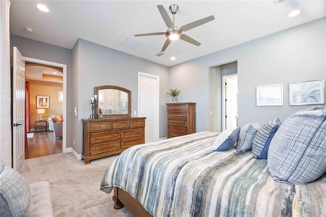 bedroom with ceiling fan and light carpet