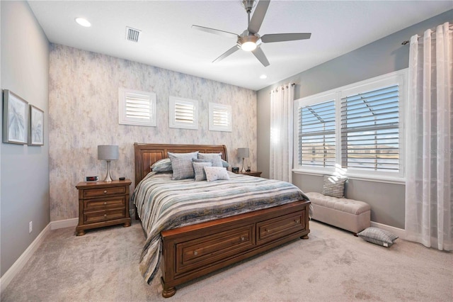 carpeted bedroom with multiple windows and ceiling fan